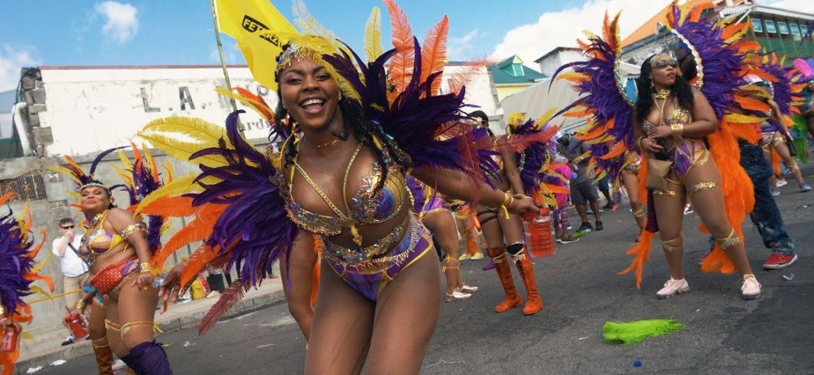 Colorful costumed performers dancing during Carnival in Dominica 2025