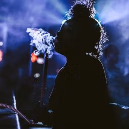 Nightlife in Dominica with people dancing, live music, and beach bars under the stars