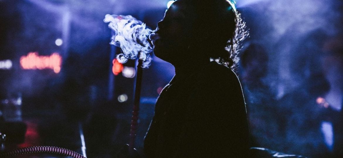 Nightlife in Dominica with people dancing, live music, and beach bars under the stars