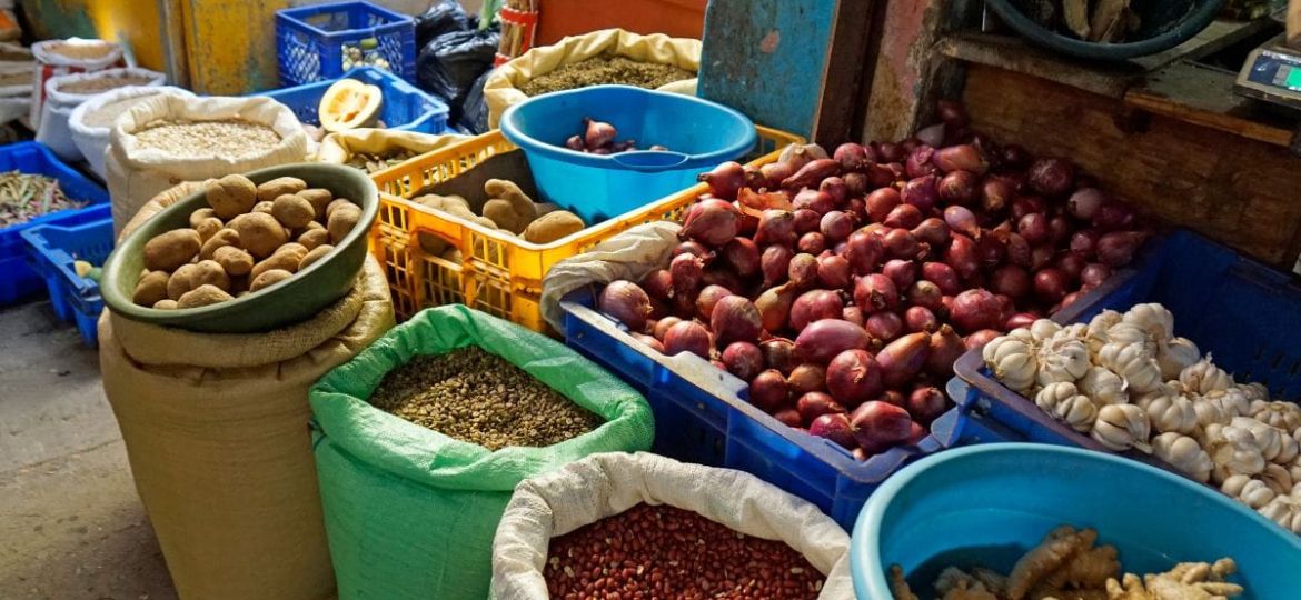 People celebrating Creole Day in Dominica wearing madras clothing, dancing and enjoying traditional food
