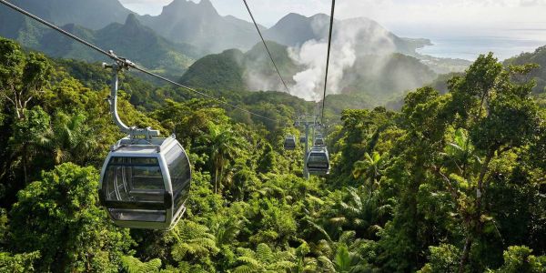 A modern Dominica Cable Car cabin gliding over the dense rainforest towards the Boiling Lake.
