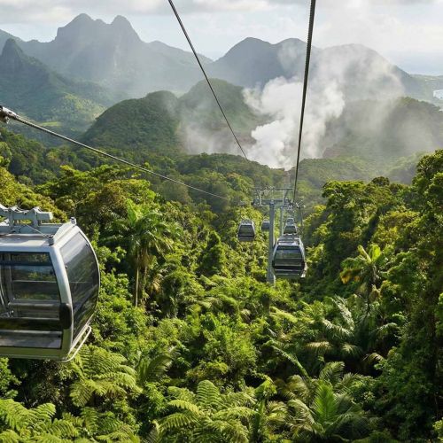 A modern Dominica Cable Car cabin gliding over the dense rainforest towards the Boiling Lake.